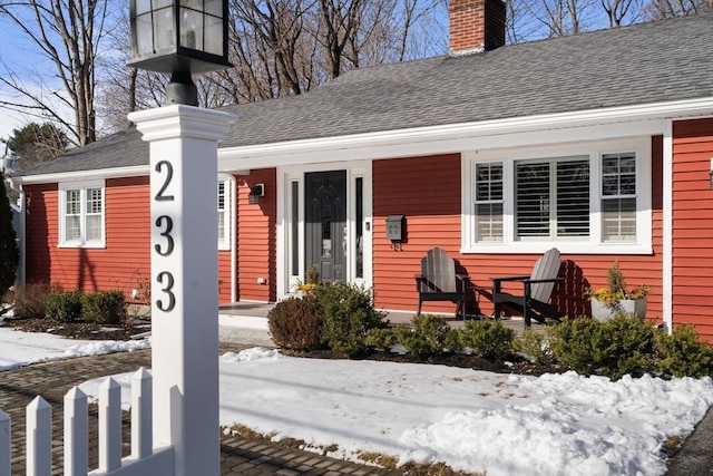 view of snow covered property entrance