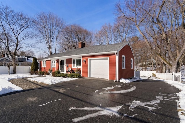 ranch-style home featuring a garage