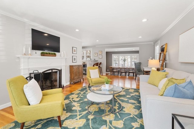 living room featuring light hardwood / wood-style flooring and ornamental molding