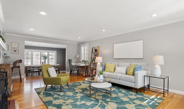 living room with wood-type flooring and ornamental molding