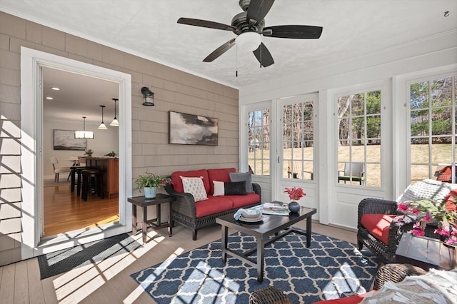 sunroom / solarium featuring ceiling fan