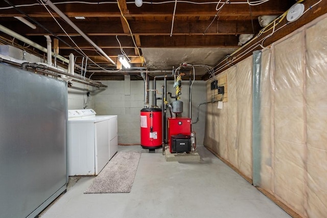 unfinished below grade area with gas water heater, concrete block wall, separate washer and dryer, and a heating unit