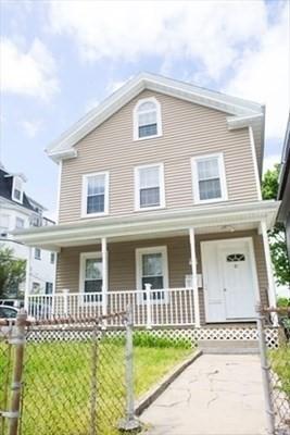 view of front of property featuring a porch and a fenced front yard