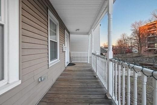 balcony at dusk with covered porch