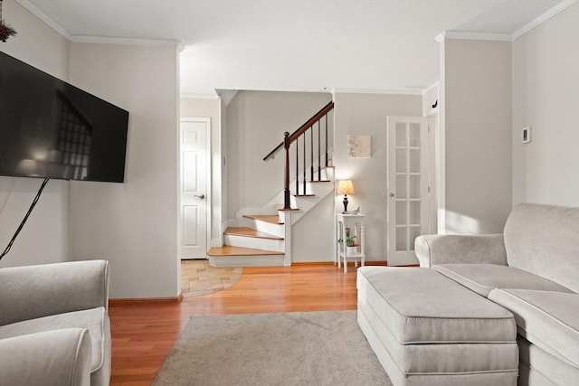 living room with baseboards, stairway, wood finished floors, and ornamental molding