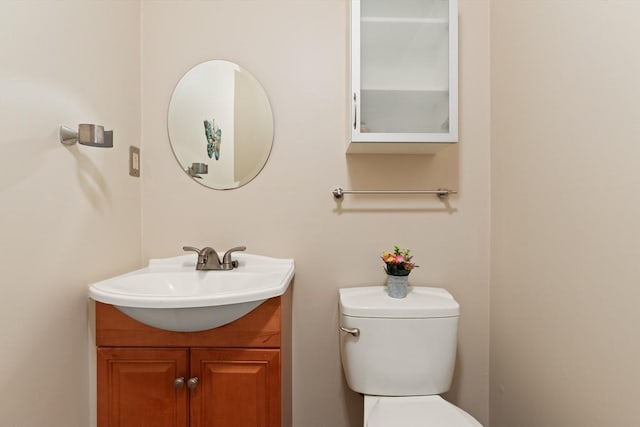 half bath featuring toilet and vanity