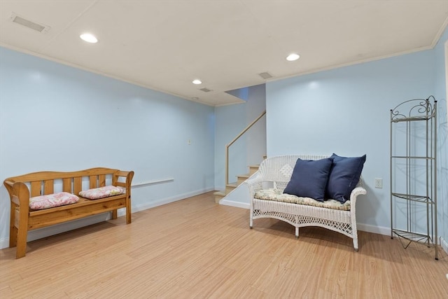 sitting room with recessed lighting, wood finished floors, visible vents, baseboards, and ornamental molding