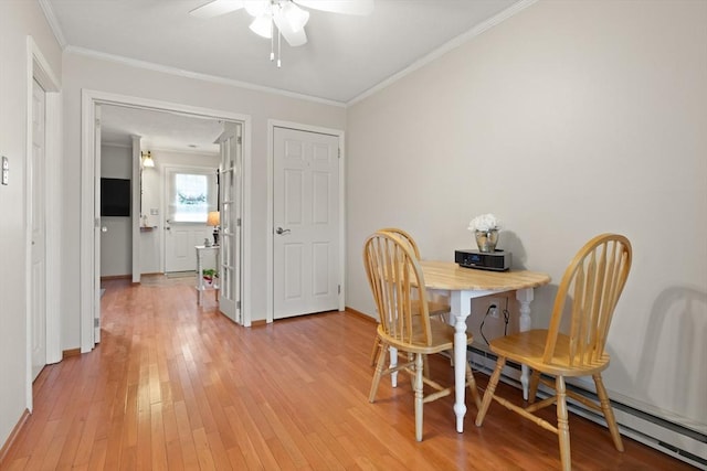 dining room featuring ceiling fan, a baseboard radiator, baseboards, light wood-style floors, and crown molding