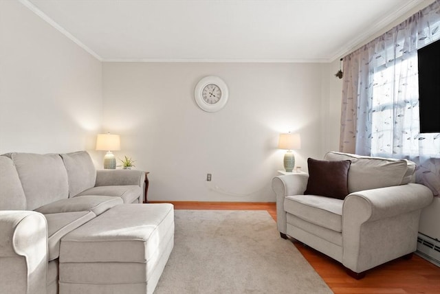 living area featuring baseboards, ornamental molding, baseboard heating, and wood finished floors