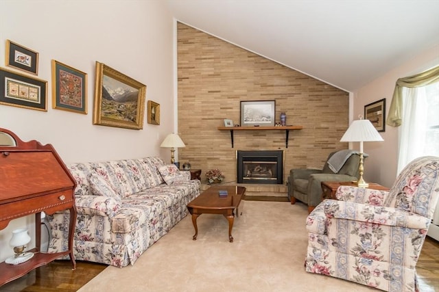 living room with lofted ceiling and a large fireplace