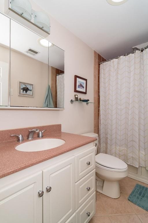 bathroom featuring toilet, vanity, visible vents, and tile patterned floors