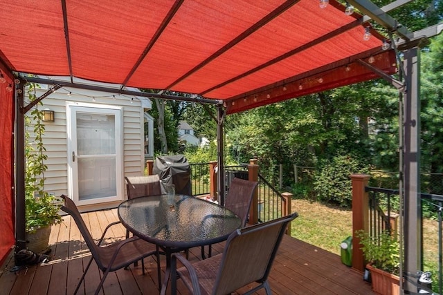 wooden deck with outdoor dining area, grilling area, and a pergola