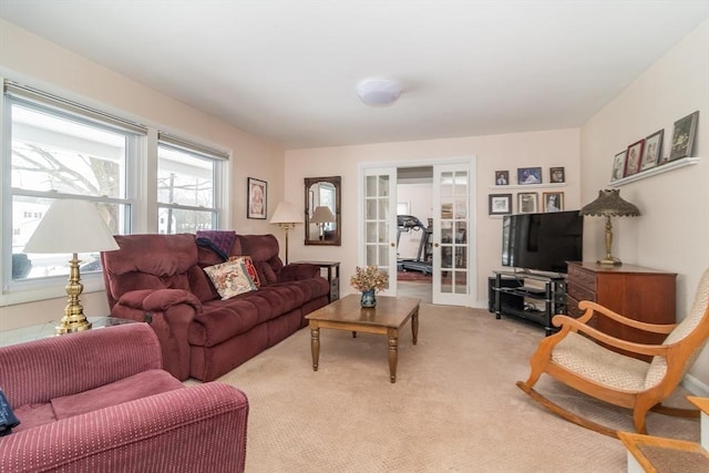 living room featuring light colored carpet and french doors