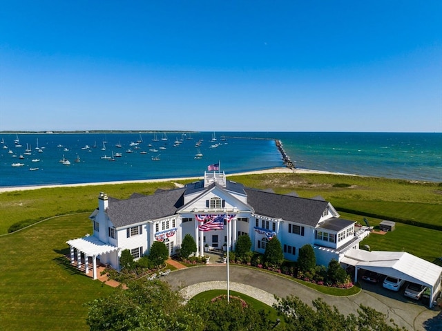 drone / aerial view featuring a water view and a beach view