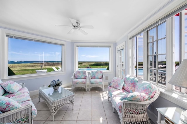 sunroom / solarium featuring ceiling fan