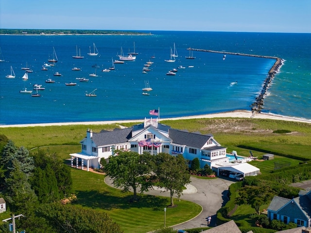 drone / aerial view featuring a water view and a view of the beach