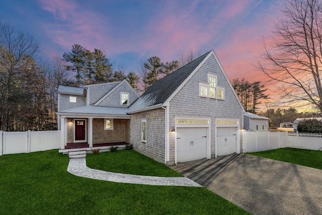 view of front facade with a yard and a garage