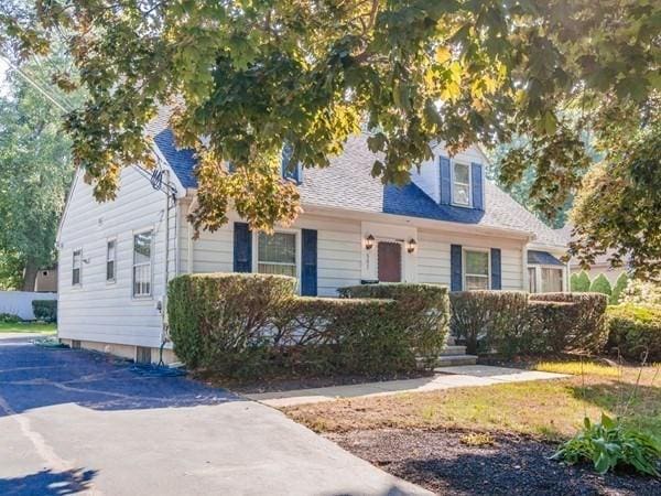 cape cod house with roof with shingles