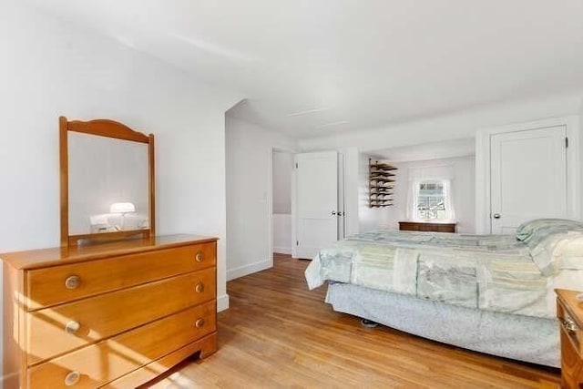 bedroom featuring baseboards and light wood-style floors