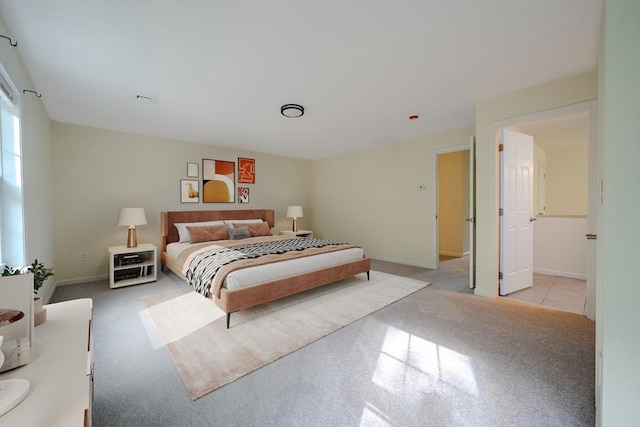bedroom featuring baseboards, light carpet, and visible vents