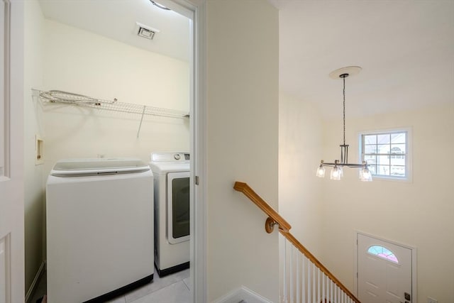 laundry room with laundry area, visible vents, separate washer and dryer, a chandelier, and light tile patterned floors