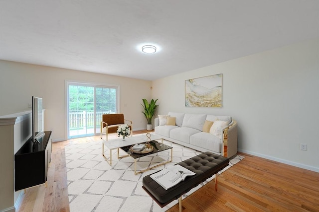 living area with baseboards and light wood-style floors
