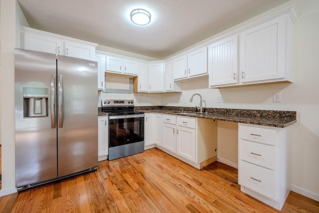 kitchen with white cabinetry, stainless steel appliances, and a sink