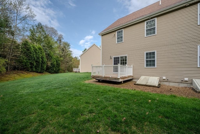 back of house with a yard and a wooden deck