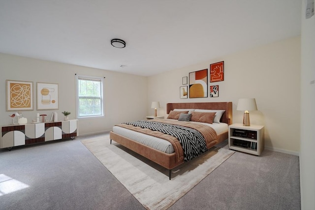 carpeted bedroom featuring baseboards