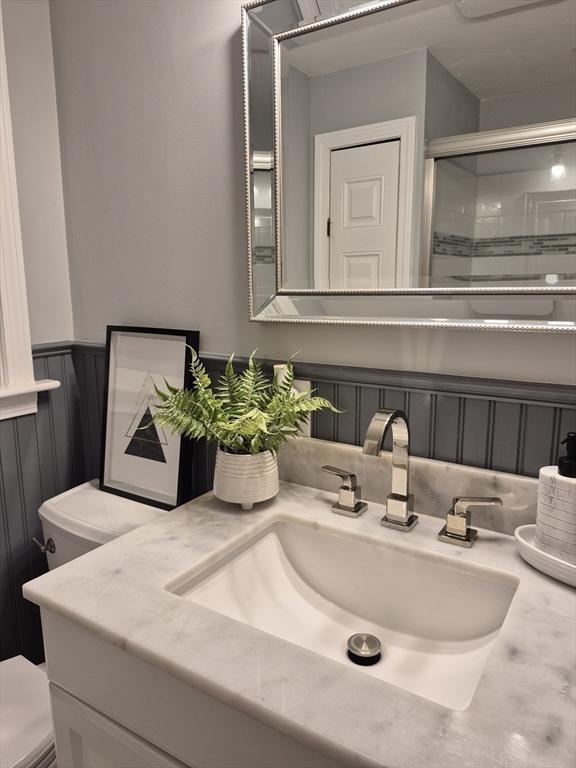 2 Neponset Pl, Canton, MA 02021 - bathroom with toilet, a shower stall, vanity, and wainscoting