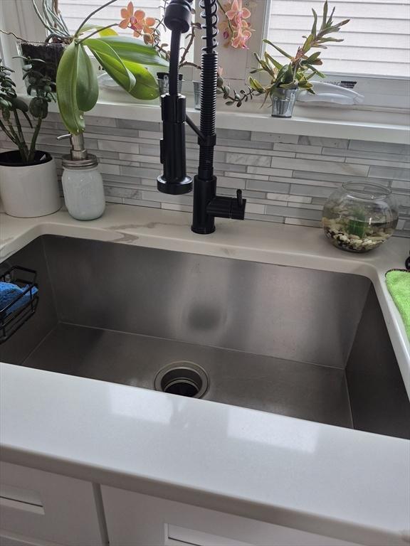 2 Neponset Pl, Canton, MA 02021 - kitchen view of a sink, backsplash, and light countertops