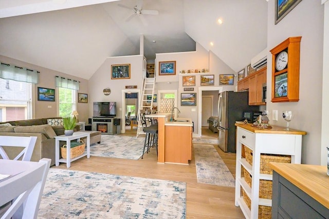 16 White Pine Knl Unit 199, Westford, MA 01886 - kitchen featuring high vaulted ceiling, open floor plan, a ceiling fan, a breakfast bar, and light wood-type flooring