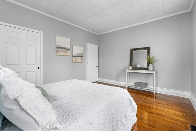 bedroom with ornamental molding and dark hardwood / wood-style floors