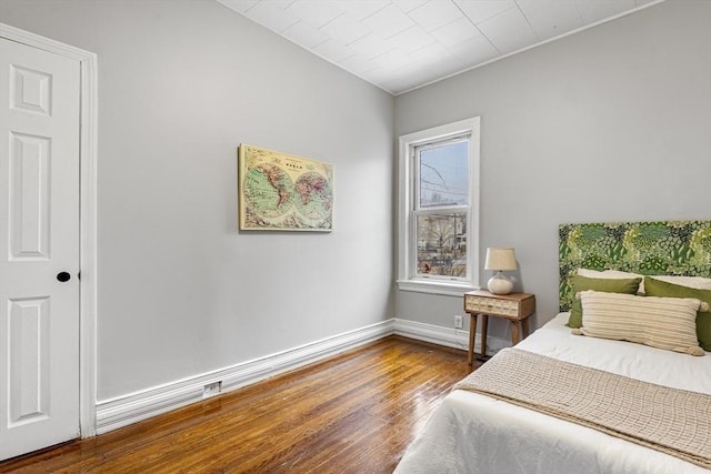 bedroom with hardwood / wood-style flooring