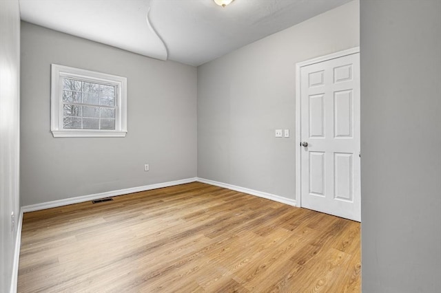 spare room featuring light wood-type flooring