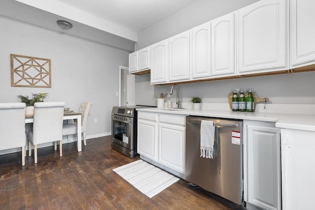 kitchen with stainless steel appliances, white cabinetry, sink, and dark wood-type flooring