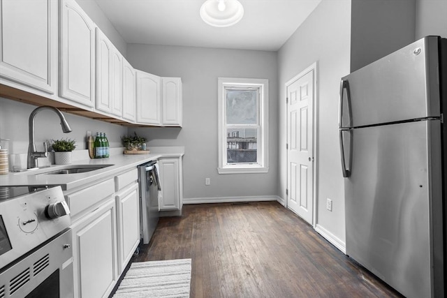 kitchen with white cabinetry, appliances with stainless steel finishes, dark hardwood / wood-style floors, and sink