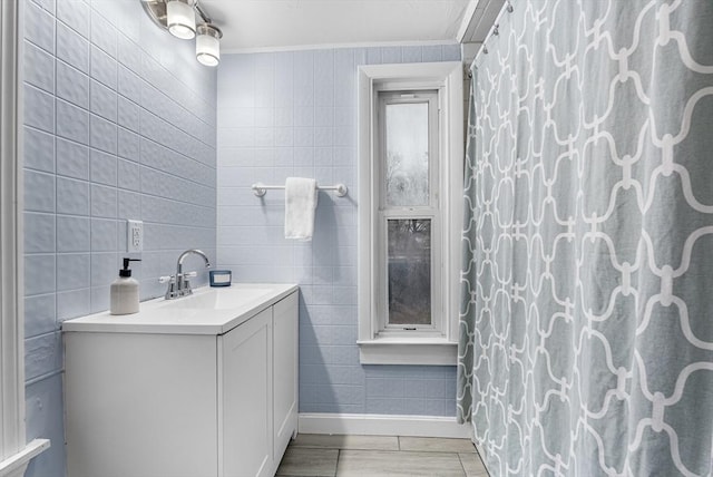 bathroom featuring vanity, ornamental molding, tile walls, and a shower with shower curtain