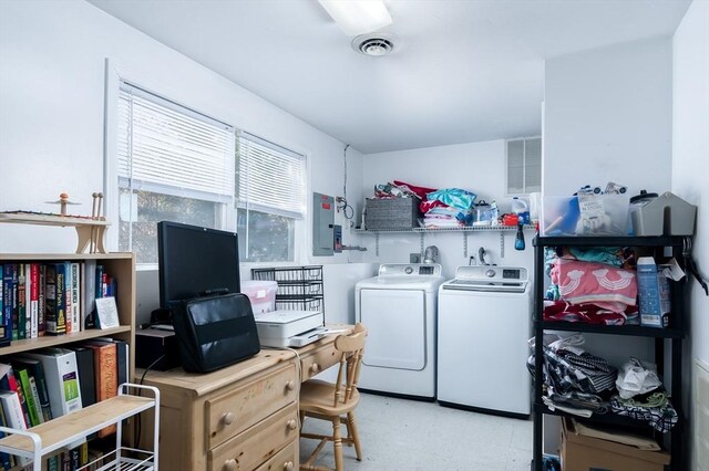 washroom with washing machine and dryer, an office area, light flooring, and electric panel