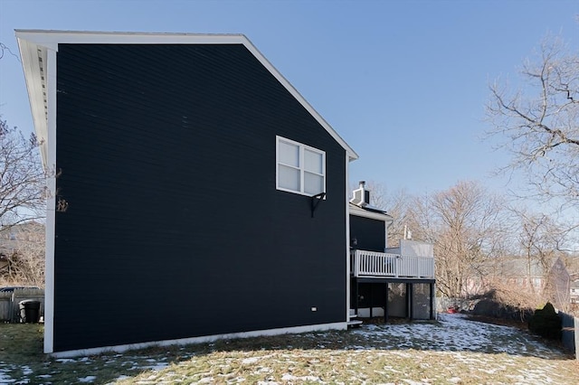 view of snow covered exterior featuring a wooden deck