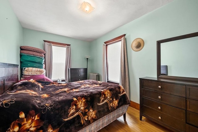 562 Broadway, Everett, MA 02149 - bedroom featuring wood finished floors and radiator