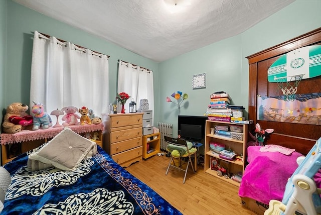 562 Broadway, Everett, MA 02149 - bedroom with wood finished floors and radiator heating unit