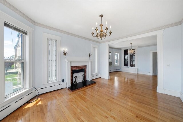 562 Broadway, Everett, MA 02149 - unfurnished living room with a chandelier, light wood-style floors, a baseboard heating unit, a brick fireplace, and baseboard heating