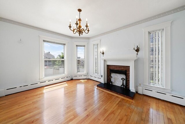 562 Broadway, Everett, MA 02149 - unfurnished living room with a chandelier, a fireplace, hardwood / wood-style flooring, a baseboard heating unit, and ornamental molding