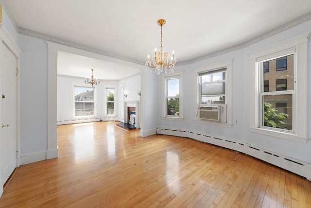 562 Broadway, Everett, MA 02149 - unfurnished living room with a chandelier, light wood-style flooring, baseboard heating, ornamental molding, and cooling unit