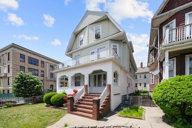 562 Broadway, Everett, MA 02149 - view of front of house featuring covered porch and stucco siding