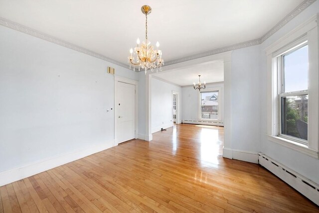 562 Broadway, Everett, MA 02149 - empty room with a chandelier, a baseboard radiator, light wood finished floors, and ornamental molding