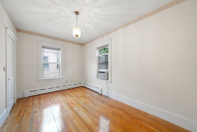 562 Broadway, Everett, MA 02149 - empty room featuring light wood-style floors, ornamental molding, and cooling unit