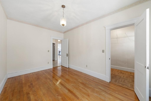 562 Broadway, Everett, MA 02149 - spare room with light wood-style floors and ornamental molding