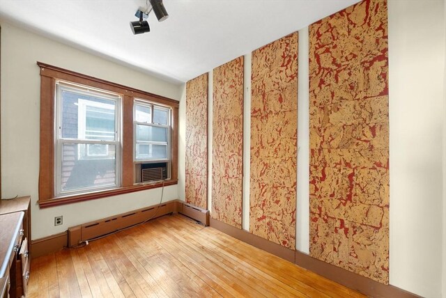 562 Broadway, Everett, MA 02149 - empty room with a baseboard heating unit, light wood-type flooring, and cooling unit